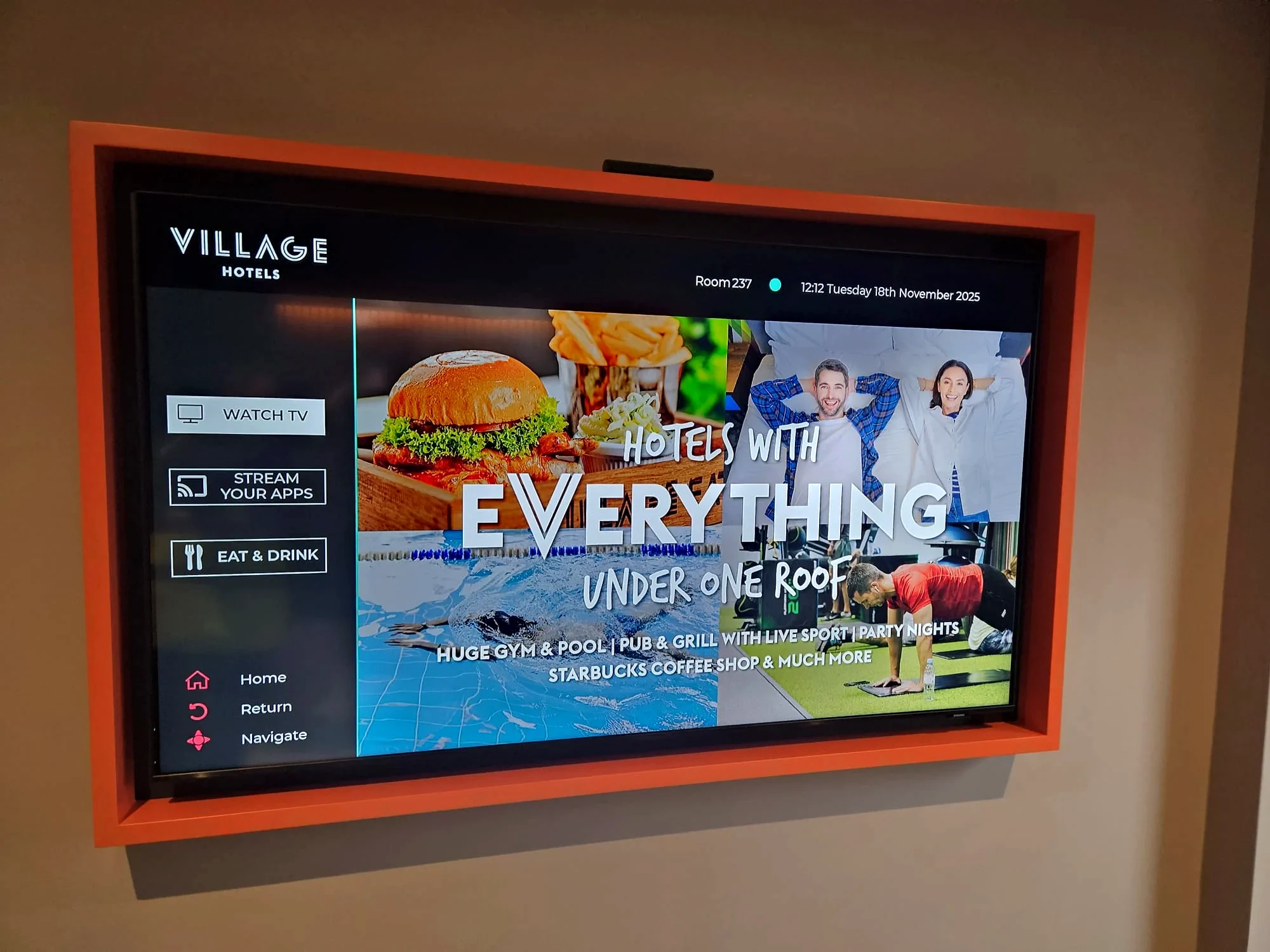 Village Hotels bedroom TV with branded welcome and entertainment menu